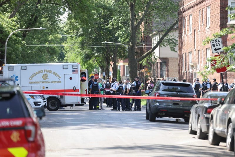 Police officers at the scene where a person was shot during a standoff with police Friday morning in the 100 block of South Kilpatrick Avenue.