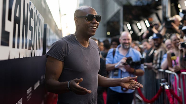 Comedian Dave Chappelle surprises couple by photobombing their wedding photos