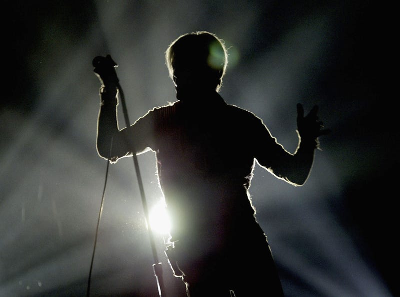 David Bowie in silhouette performs on the first night of his UK tour at the MEN Arena on November 17, 2003 in Manchester, England.