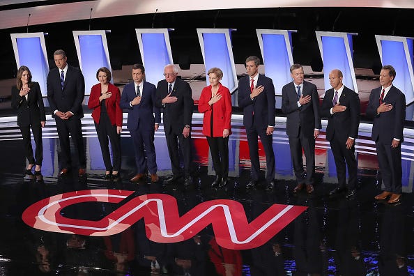The Democratic candidates are pictured during the national anthem.