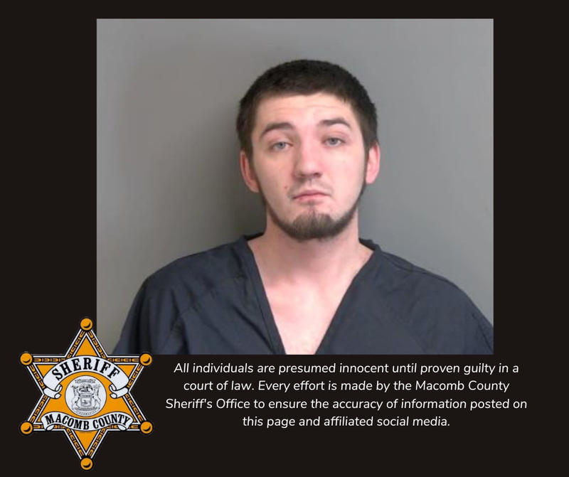 Mugshot of young, dark-haired man