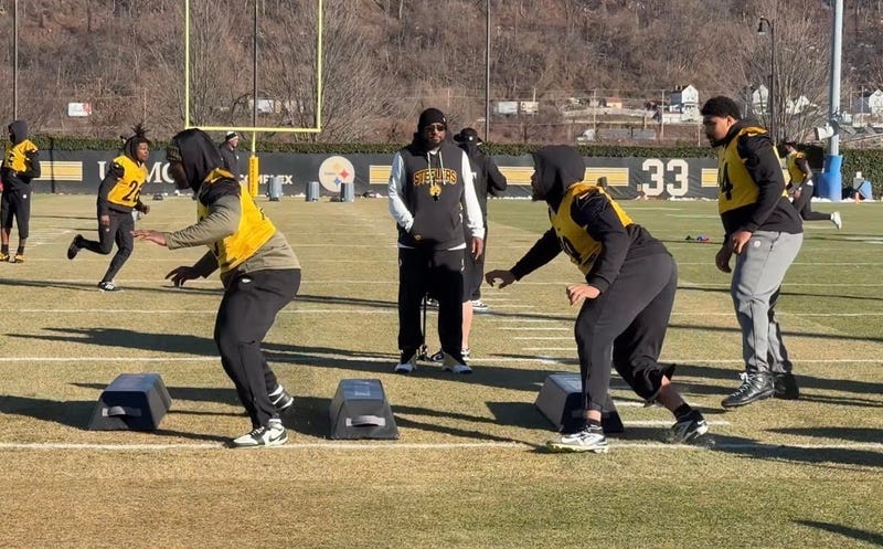 Derrick Harmon going through drills w Mike Tomlin watching