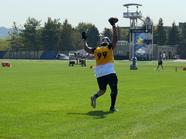 Derrick Harmon with arms in air