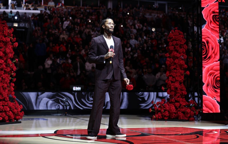 Bulls great Derrick Rose speaks to the crowd during a halftime speech.