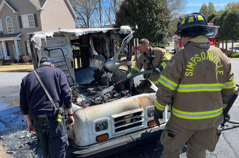 Simpsonville fire personnel finish controlling the fire that erupted from a mail truck