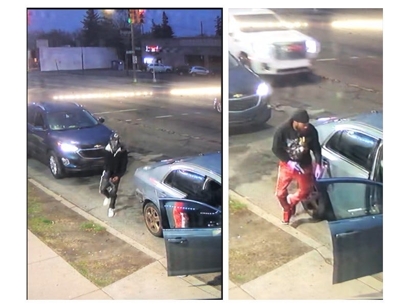 Armed robbery suspects approaching victim's car