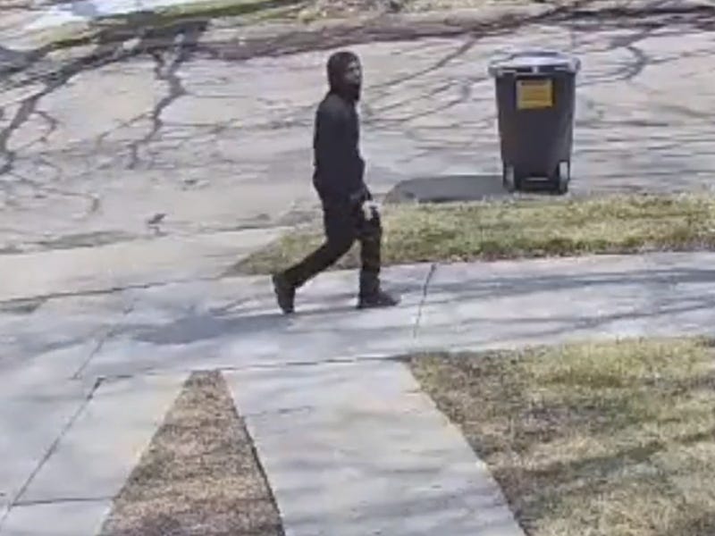 Suspect in sexual assault walking on the sidewalk