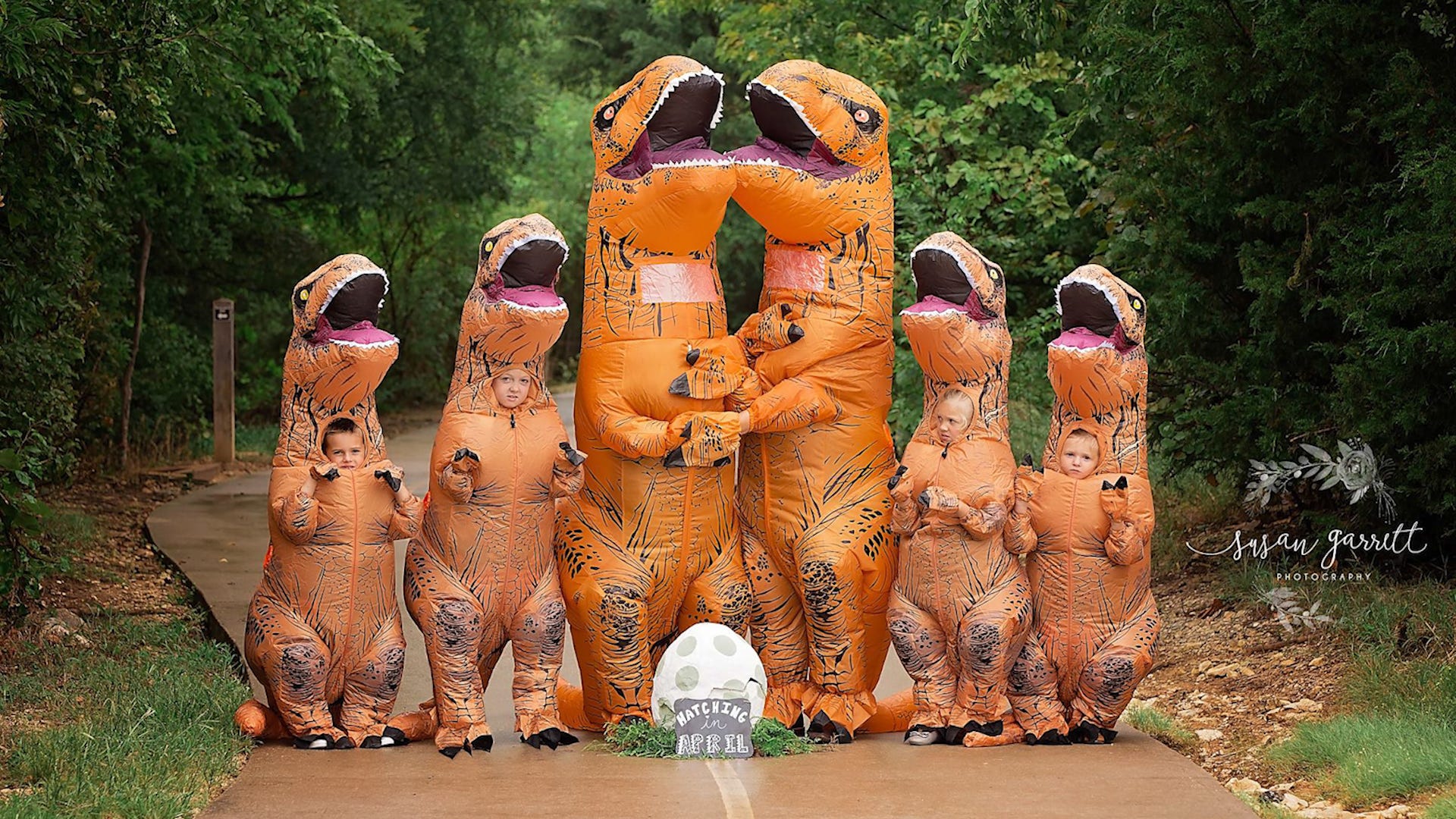 Family Makes Incredible Pregnancy Announcement Wearing Inflatable T-Rex Costumes