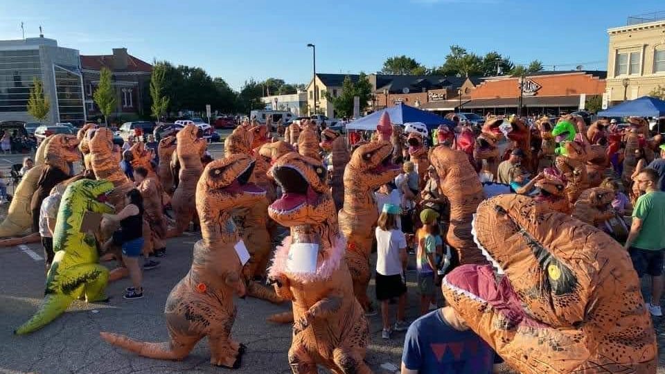 Store owner trying to break world record for largest gathering of people dressed as dinosaurs