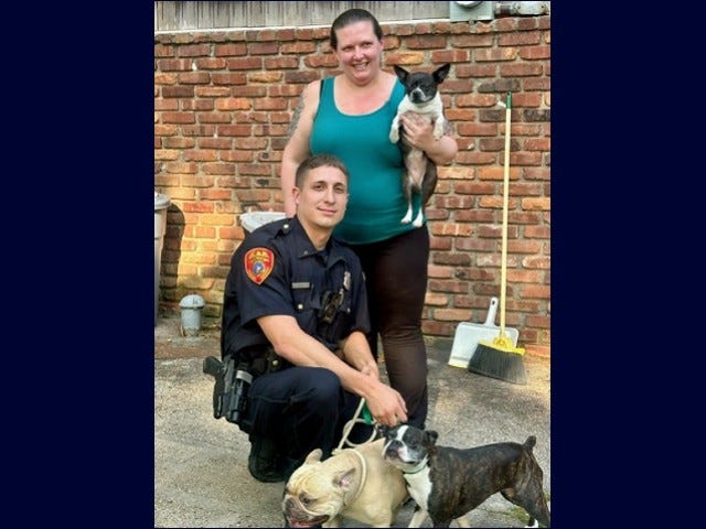 Suffolk County Police Officer Matthew Ingui and the three dogs he rescued from a Long Island house fire on Sunday.