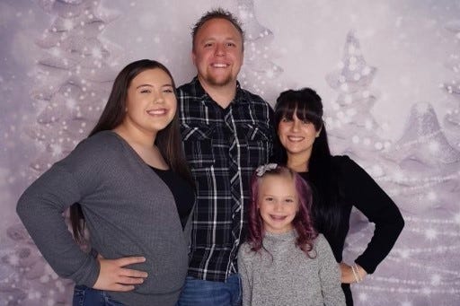 Metro Police officer Douglas King poses for a picture with his family
