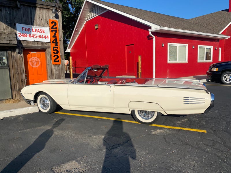 Cream colored Ford Thunderbird parked at Woodward Dream Cruise