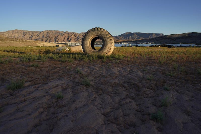 A truck tire once in the water as part of a marina sits on dry ground as water levels have dropped near the Callville Bay Resort & Marina in the Lake Mead National Recreation Area, Tuesday, Aug. 30, 2022, near Boulder City, Nev.
