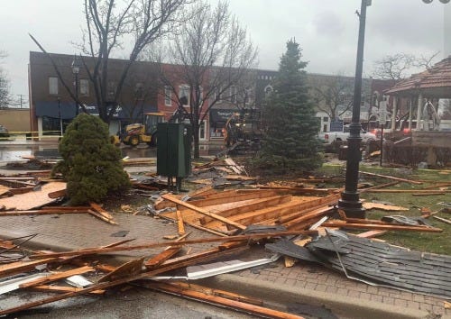 Downtown Dundee after a severe storm with high winds. Wood and roofing debris is strewn around the village square.
