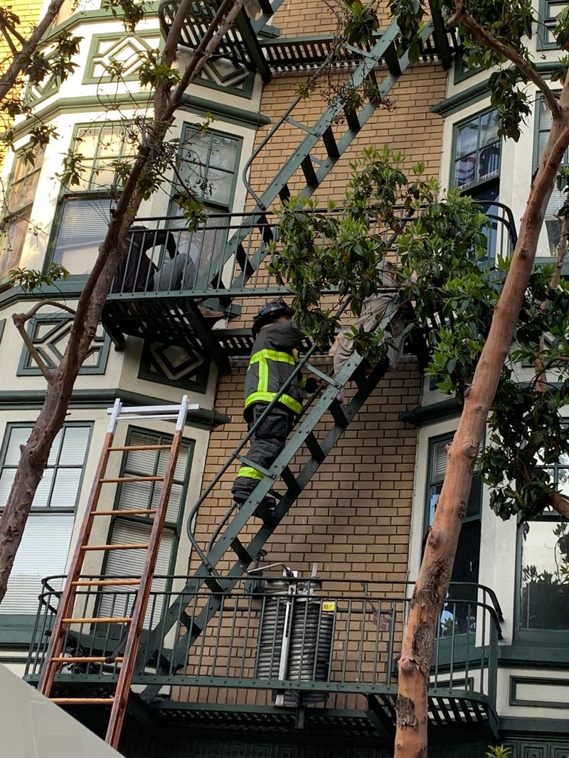 Residents of an apartment building on Leavenworth Street assisted by the San Francisco Fire Department during a structure fire in their building, June 19, 2021.