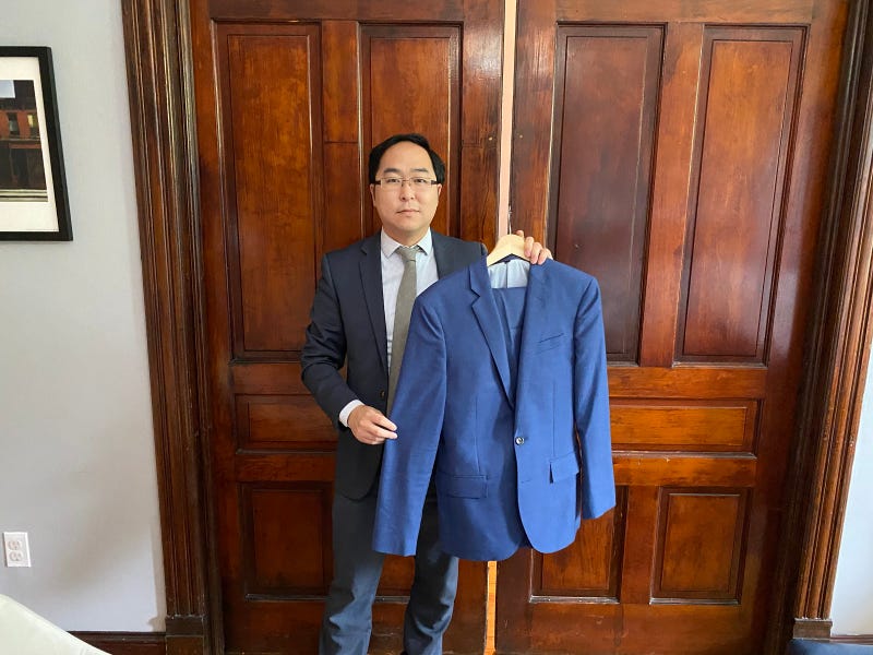 Rep. Andy Kim holds the blue J. Crew suit he wore while cleaning up the aftermath of the Jan. 6 riots.