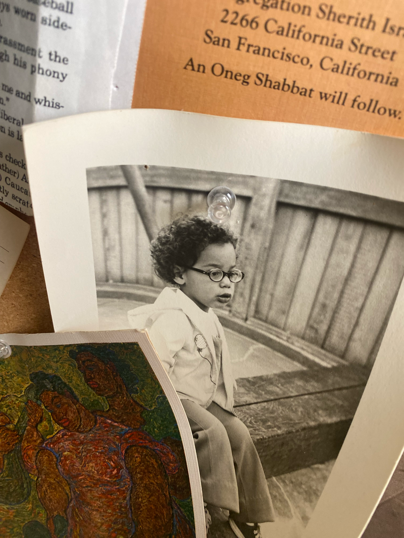 A photo of Ilana Kaufman as a child hangs at her mother's home outside New York City. At the upper right corner, her Bat Mitzvah announcement.