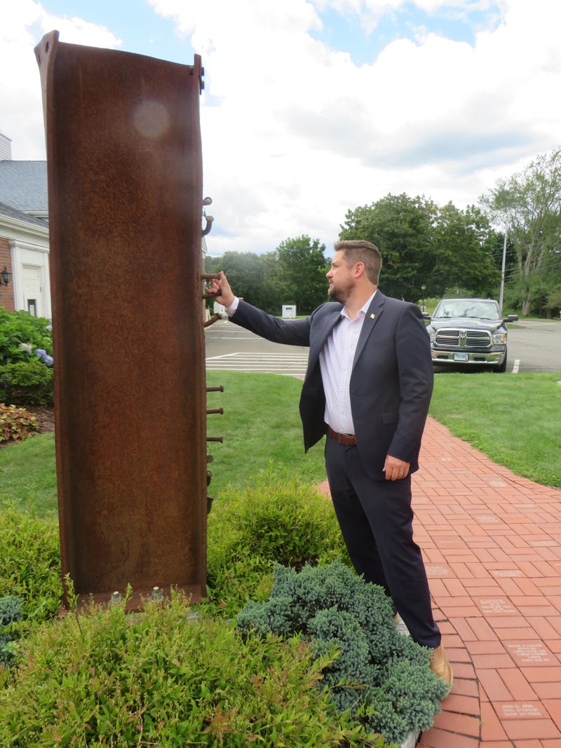 Brett Eagleson, who was 15 when his father Bruce was killed in the World Trade Center's South Tower, inspects a steel beam from that tower at the South Fire District in Middletown, CT, 9/3/21