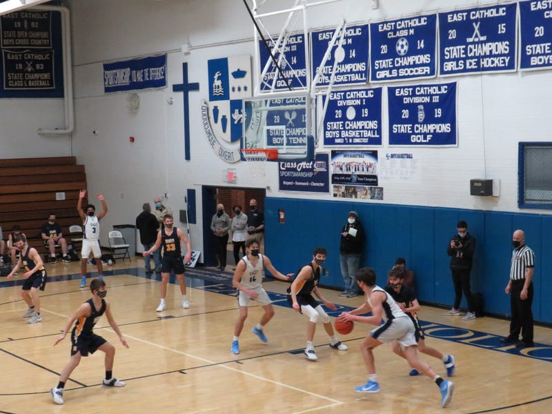 Masks in place, the state's winter high school teams have finally started their season. Here, East Catholic of Manchester hosts Rham HS of Hebron, 2/8/21.