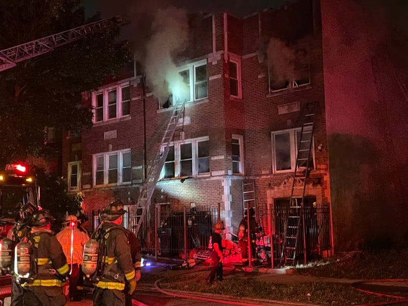 Four people were injured, including a Chicago police officer, as residents were forced to jump from an apartment building fire in Englewood on the South Side.