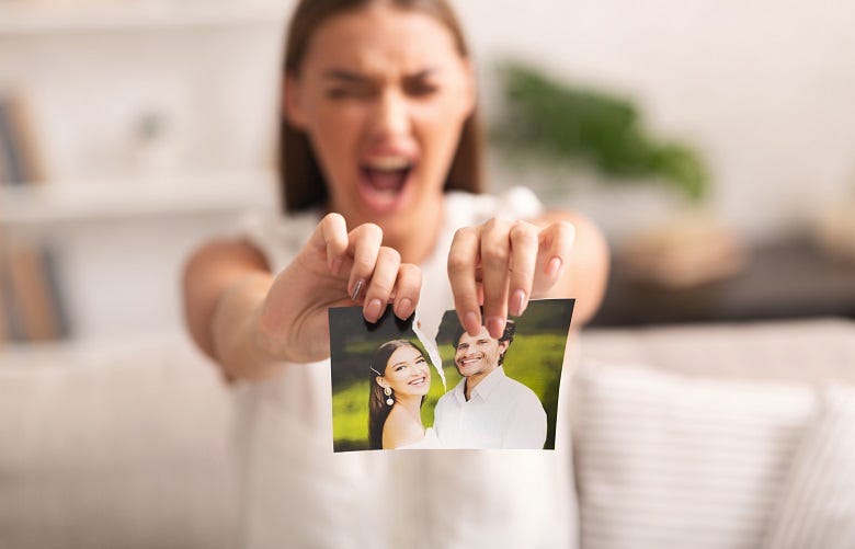 Woman tearing photo of ex