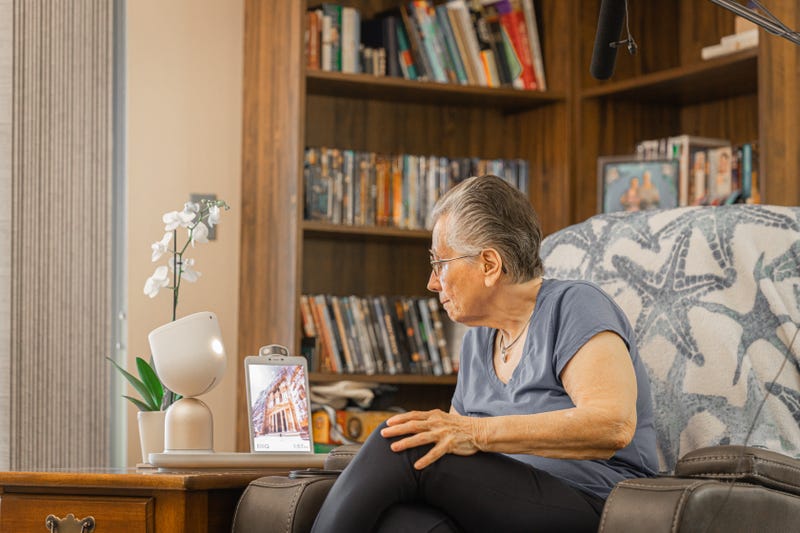 Senior Kathy Marks engages with her AI-companion, ElliQ.