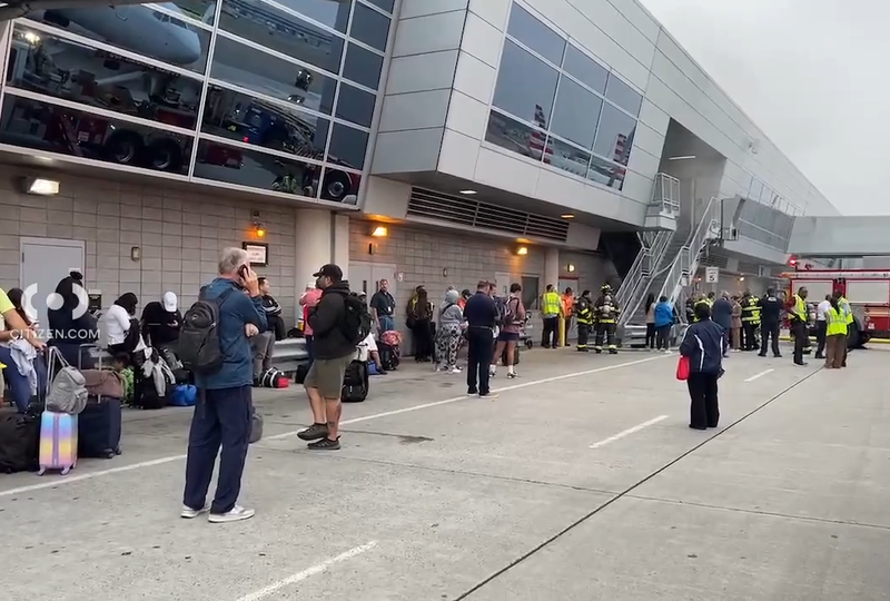 Travelers were seen on the tarmac as the fire department responded