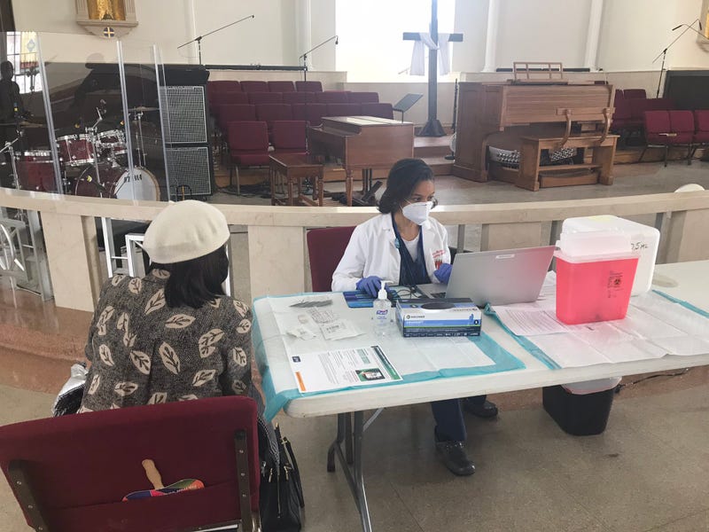 A doctor administering a COVID-19 vaccine at Salem Baptist Church of Abington.