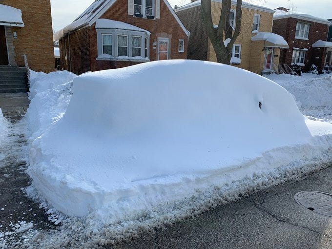 Car fully encased in snow on Chicago street