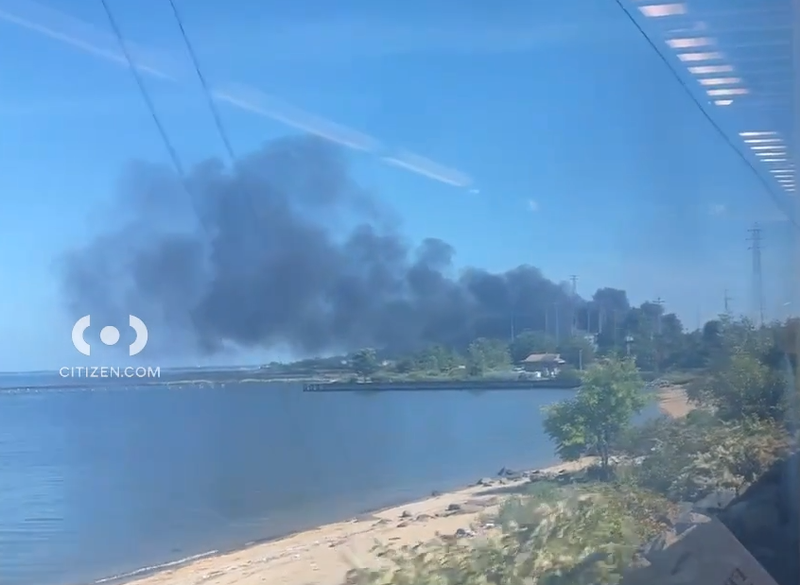 Smoke from the explosion is seen from a train