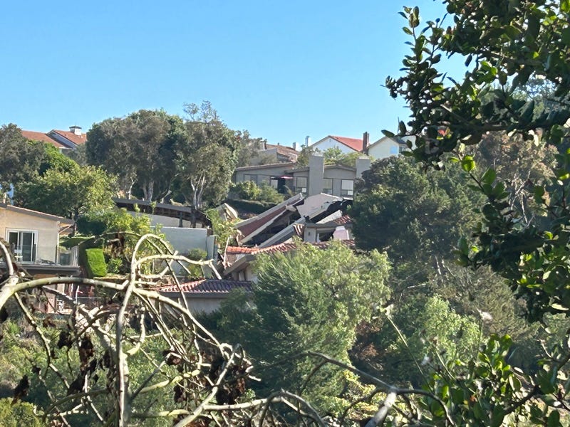 collapsed homes on hillside