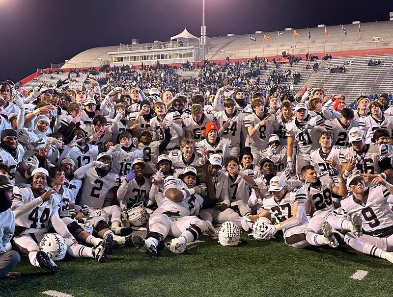 Mount Carmel football team poses for a photo after winning the 2023 IHSA 7A Championship