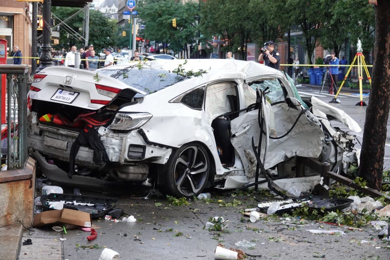 Police believe a black Mercedes-Benz ran a red light and crashed into this white Honda sedan, killing a woman in the Honda and injuring multiple people in both vehicles