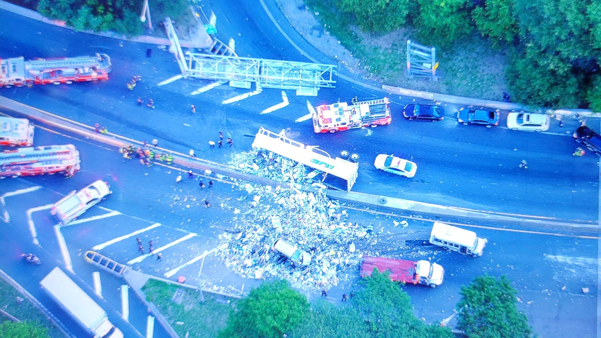 PHOTOS: Dump truck flips on BQE, toppling overhead sign and causing epic delays