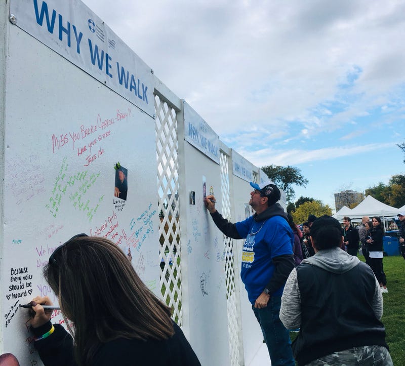 people signing message wall