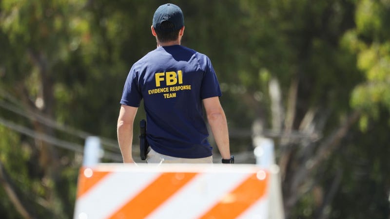 An FBI agent walks toward the site of the Gilroy Garlic Festival after a mass shooting there yesterday on July 29, 2019 in Gilroy, California.