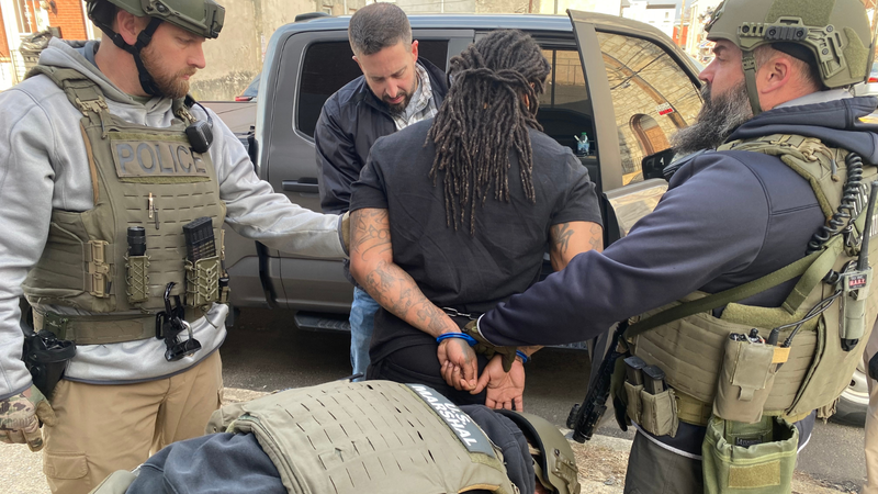 U.S. Marshals surround a handcuffed Keith Freeman after his recapture in North Philadelphia.