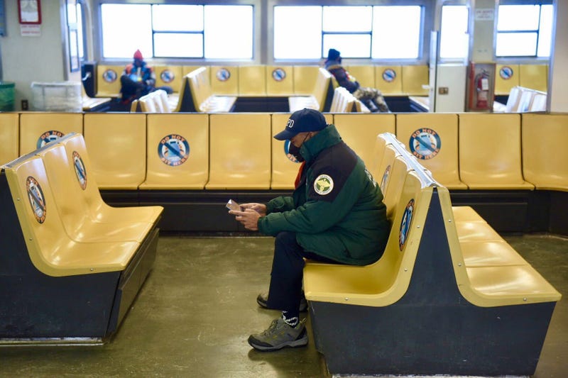 Mayor Eric Adams works while riding the Staten Island Ferry
