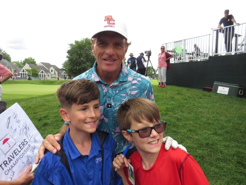 Former Boston College and NFL quarterback Doug Flutie poses with young fans Andrew and Jackson Bell of Chicopee, MA at the Travelers Pro-Am, 6/21/23 at Cromwell