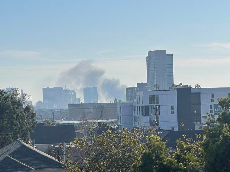 Dark clouds of smoke rose into the Oakland sky Saturday after a boat attached to a parked trailer caught fire. 