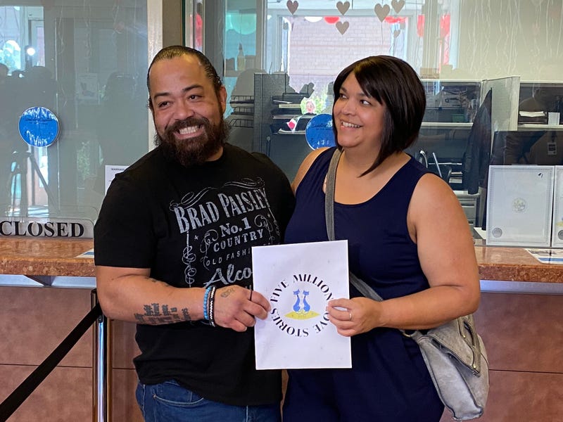 A couple receives the 5-millionth marriage license ever issued in Clark County