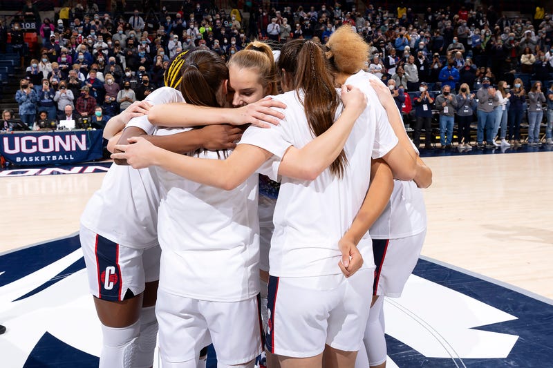 The UConn women celebrate their win over Providence on Sunday.