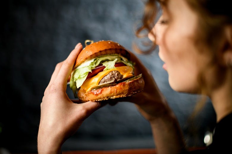 woman eating hamburger