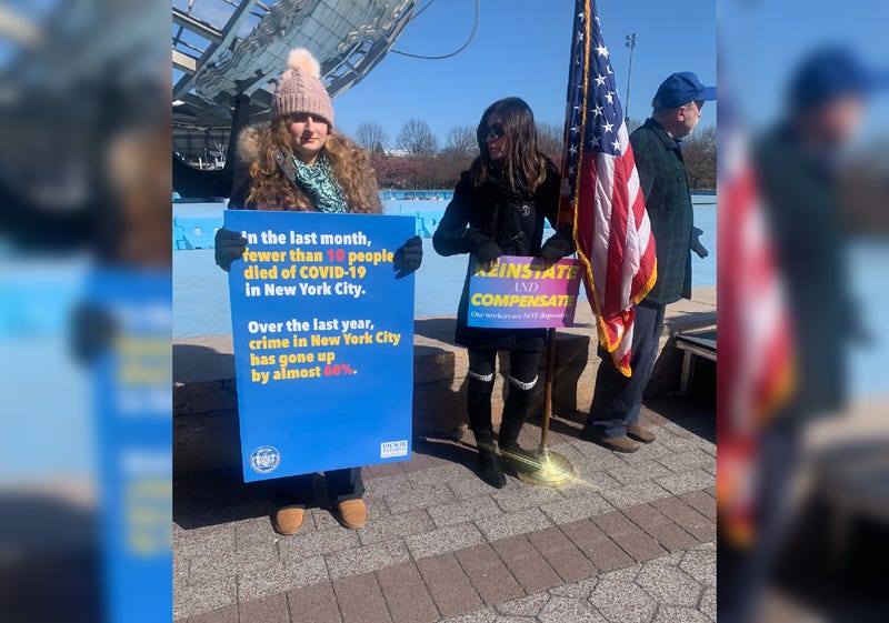 Workers rallied around the Unisphere at Flushing Meadows–Corona Park demanding to be rehired and for backpay