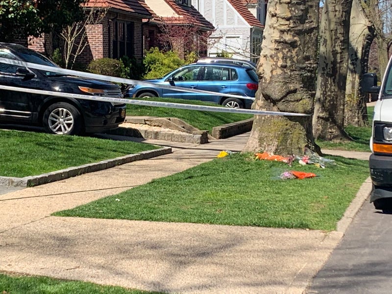 Police tape was still up outside the home Wednesday. Flowers were placed beside a tree
