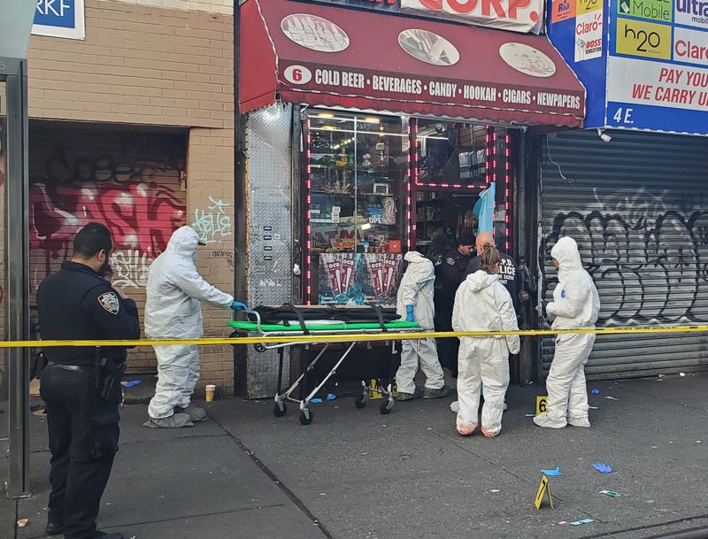 Investigators at the scene of the shooting at East Burnside and Jerome avenues in the Mt. Hope section on Tuesday morning
