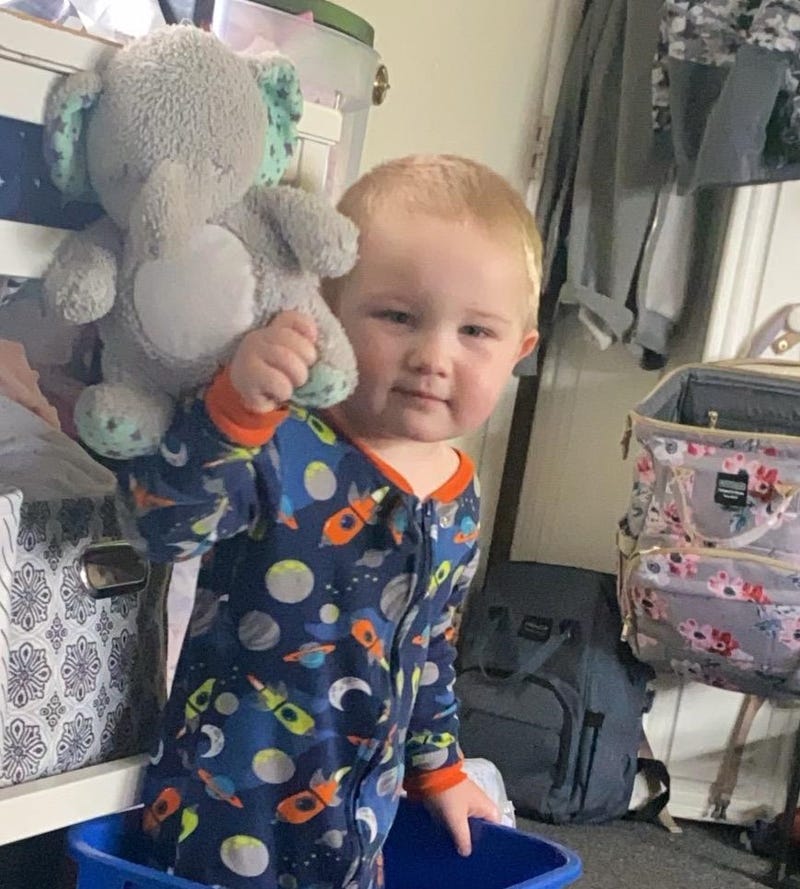 Little boy holding stuffed animal
