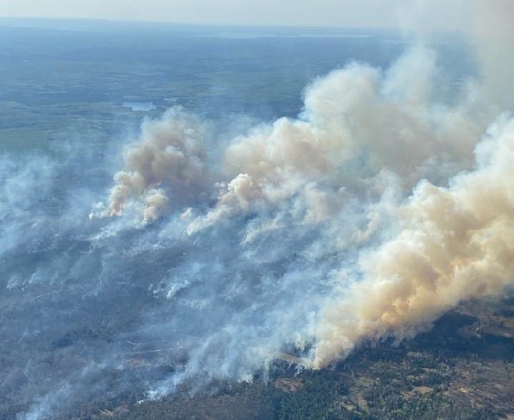 Firefighters with the Michigan Department of Natural Resources and local fire crews are battling back a raging wildfire burning Montmorency and Cheboygan counties, officials said Saturday morning.