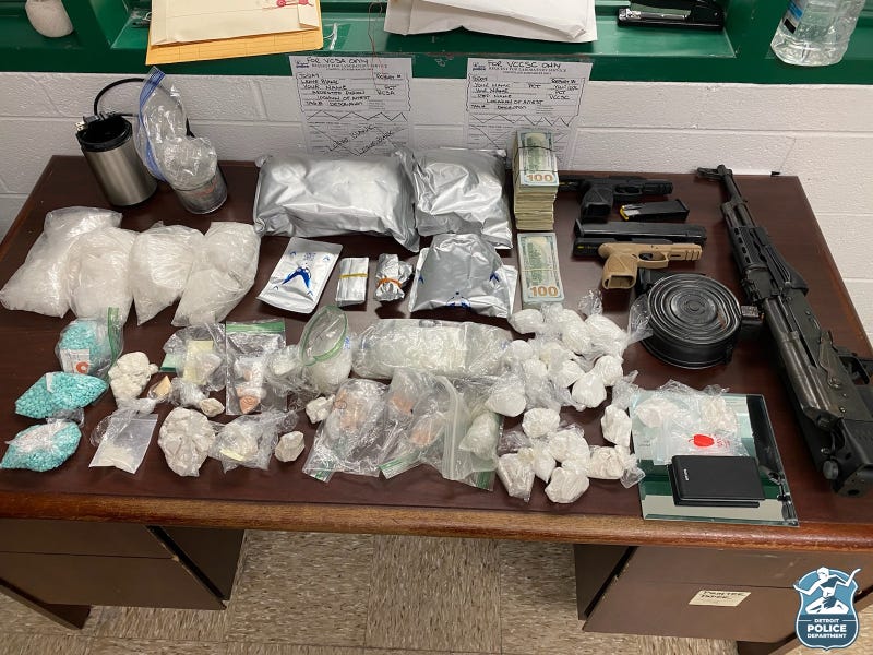 It was an unexpected double win for Detroit Police on Tuesday when they went to arrest a shooting suspect and ended up stumbling across guns and large amounts of drugs in the home.