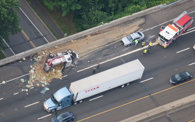 The overturned truck was seen next to fruits and vegetables covering two lanes of the Connecticut Turnpike